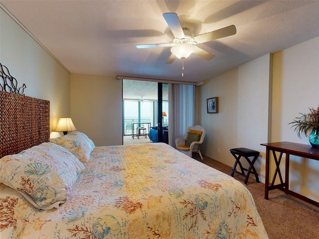 bedroom with a textured ceiling, carpet floors, and ceiling fan