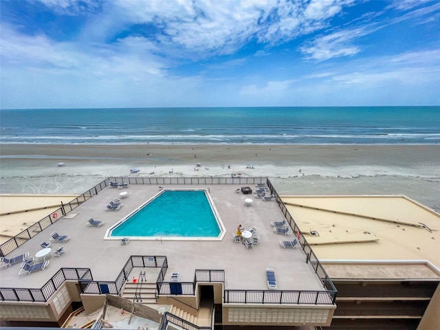 birds eye view of property with a view of the beach and a water view