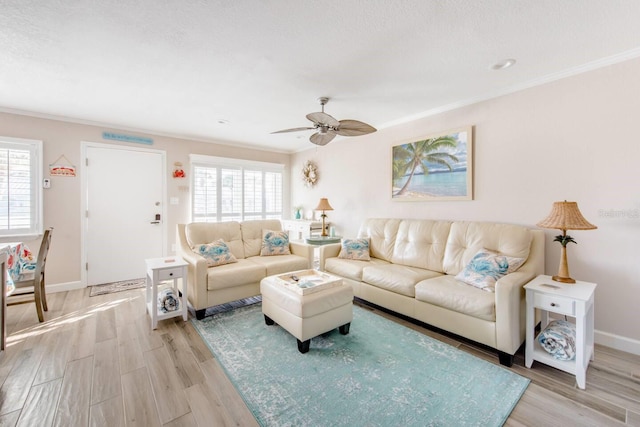 living room with crown molding, light hardwood / wood-style floors, ceiling fan, and a textured ceiling