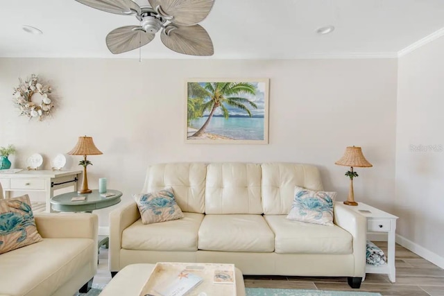 living room with ceiling fan, ornamental molding, and wood-type flooring