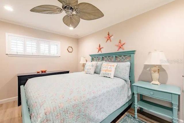 bedroom with light hardwood / wood-style flooring and ceiling fan