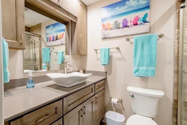 bathroom featuring vanity, toilet, and an enclosed shower