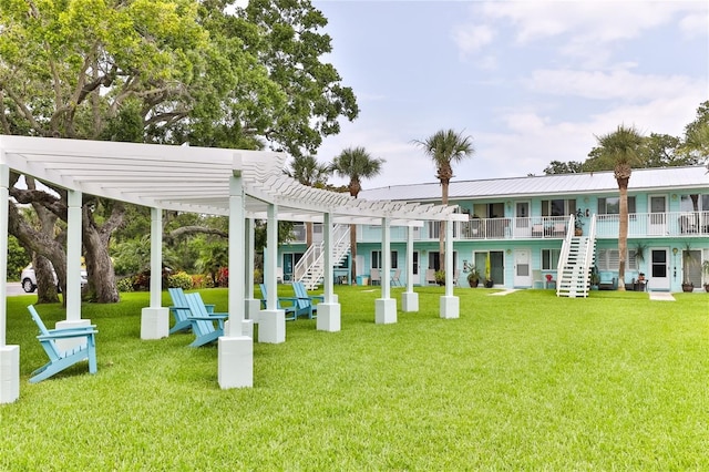 view of community with a pergola and a lawn