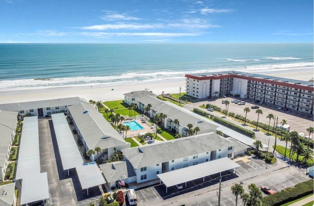 drone / aerial view with a water view and a beach view