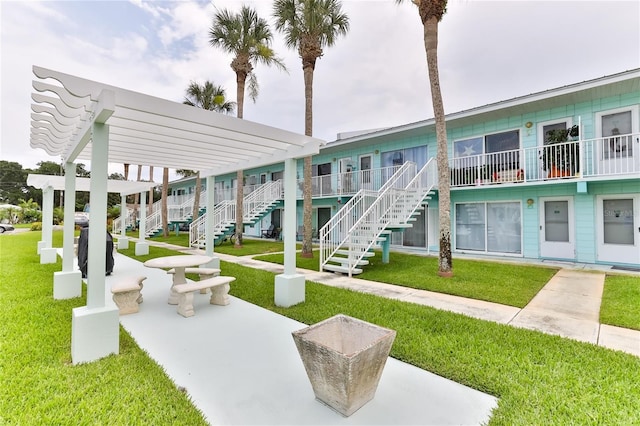 surrounding community with a patio area, a pergola, and a lawn