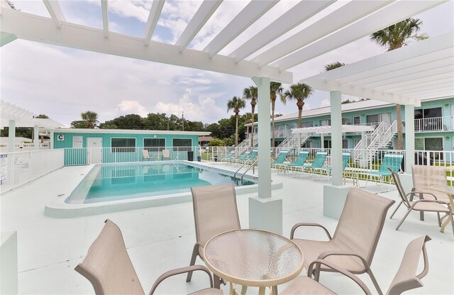 view of pool with a pergola and a patio