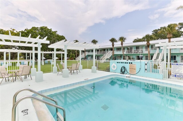 view of swimming pool featuring a pergola