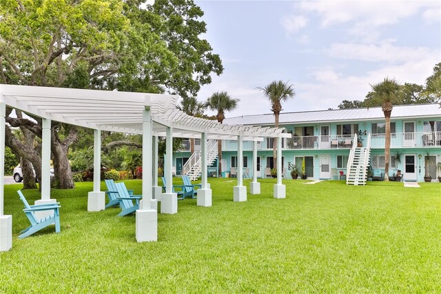 exterior space with a pergola and a lawn