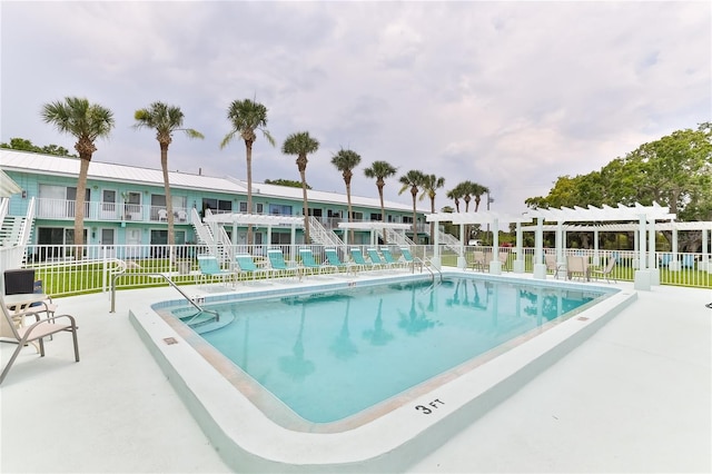 view of pool with a pergola and a patio