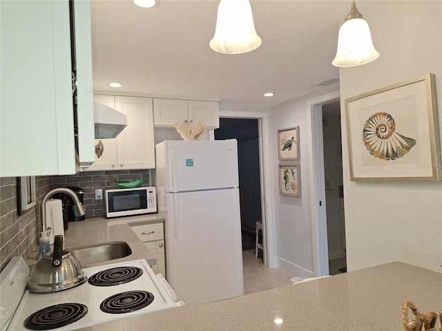 kitchen featuring white cabinets, hanging light fixtures, white appliances, extractor fan, and decorative backsplash