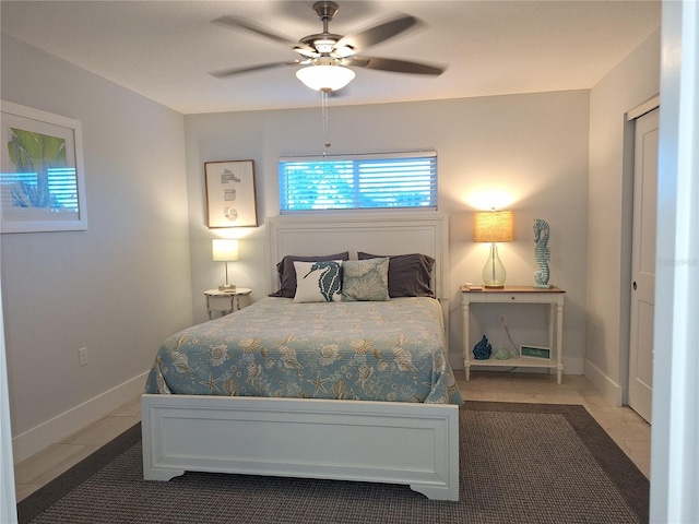 tiled bedroom featuring a closet and ceiling fan