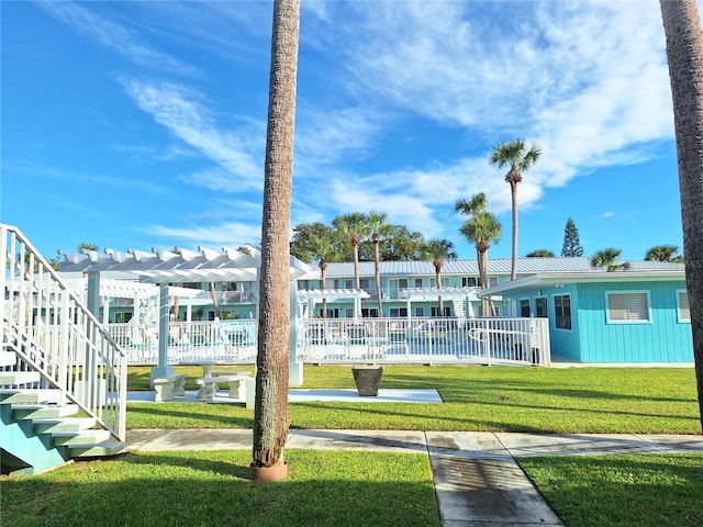 view of community with a yard and a pergola