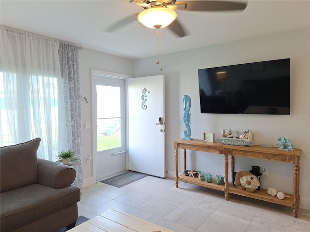 tiled foyer featuring ceiling fan