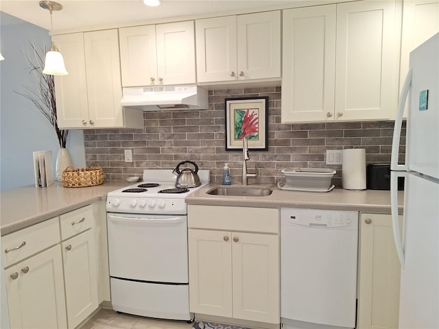 kitchen with pendant lighting, sink, white appliances, backsplash, and white cabinets