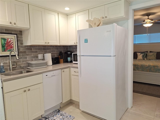 kitchen with tasteful backsplash, sink, white cabinets, white appliances, and ceiling fan