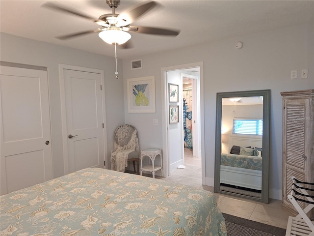 tiled bedroom featuring ceiling fan