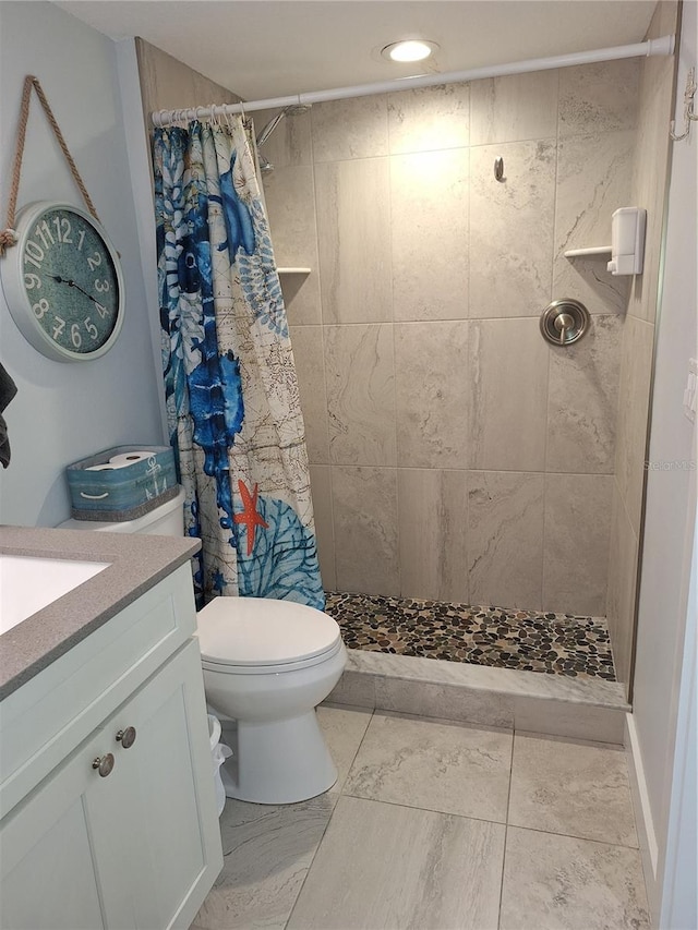 bathroom featuring a shower with curtain, vanity, and toilet