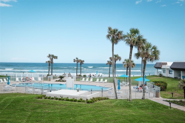 view of swimming pool with a lawn, a water view, and a patio