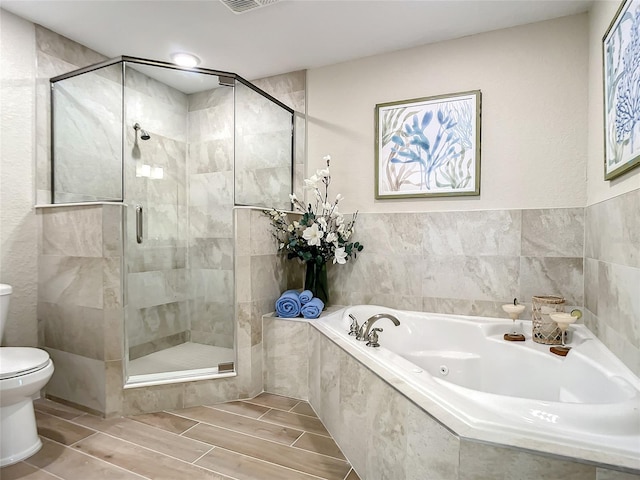 bathroom with shower with separate bathtub and toilet