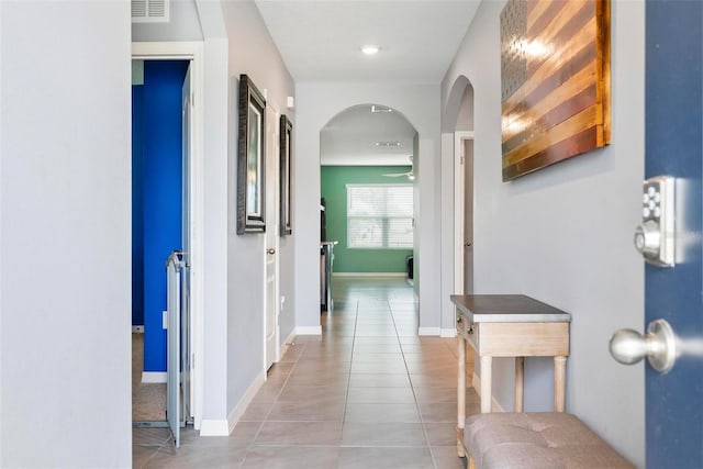 hall featuring light tile patterned floors