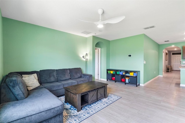 living room featuring ceiling fan and light hardwood / wood-style flooring