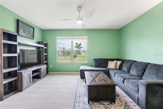 living room with ceiling fan and light hardwood / wood-style floors