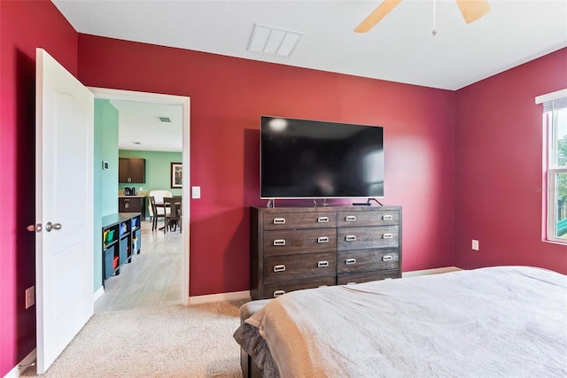 bedroom featuring ceiling fan and light colored carpet