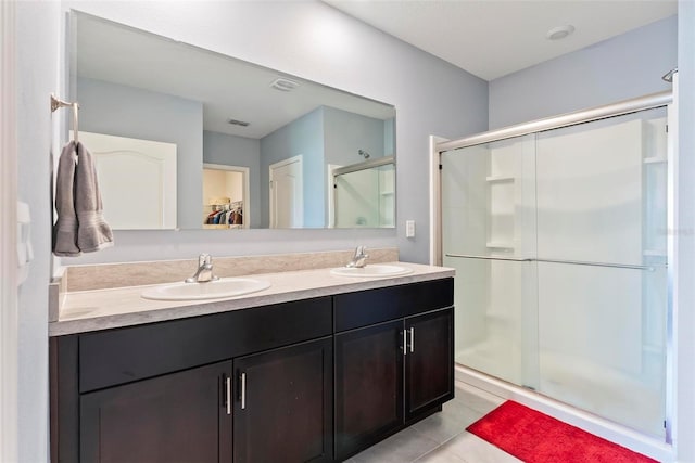 bathroom with vanity, tile patterned flooring, and a shower with shower door