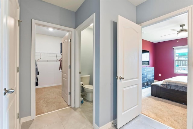 bathroom featuring ceiling fan, tile patterned floors, and toilet