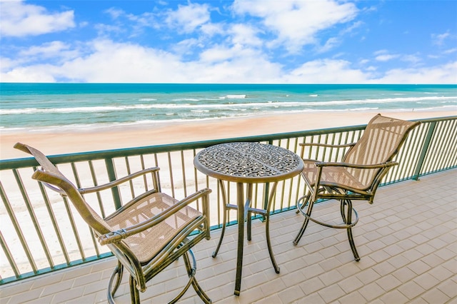 balcony with a beach view and a water view