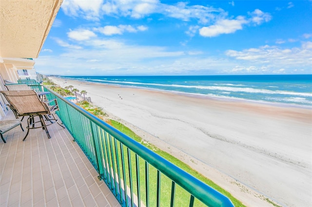 balcony with a beach view and a water view