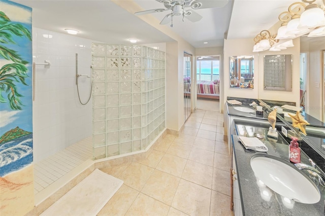 bathroom featuring tiled shower, vanity, tile patterned floors, and ceiling fan