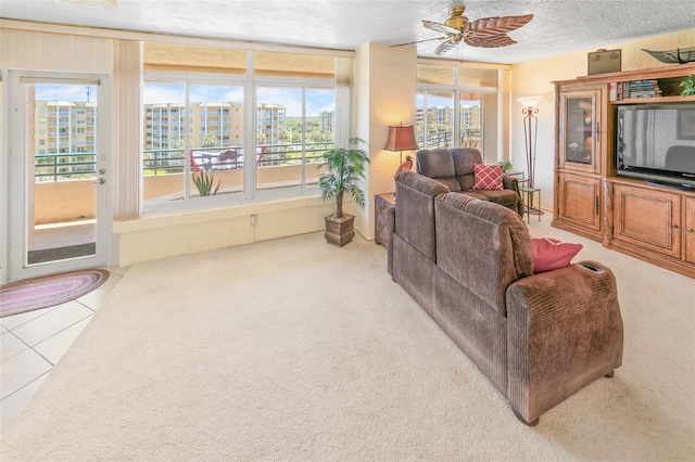 tiled living room featuring a textured ceiling and ceiling fan