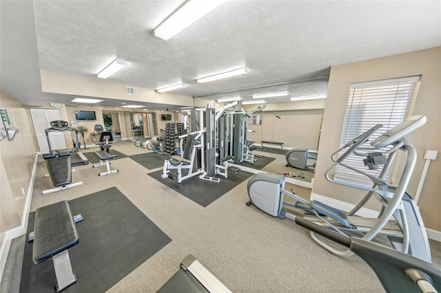 exercise room featuring a textured ceiling