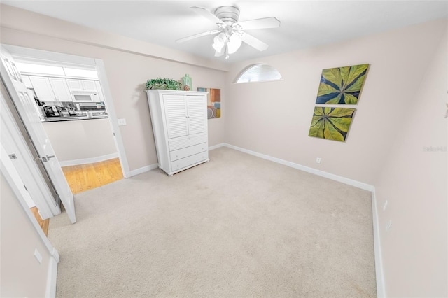 bedroom with ceiling fan and light carpet