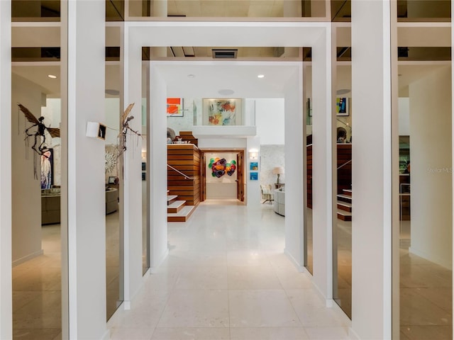 hall featuring light tile patterned floors