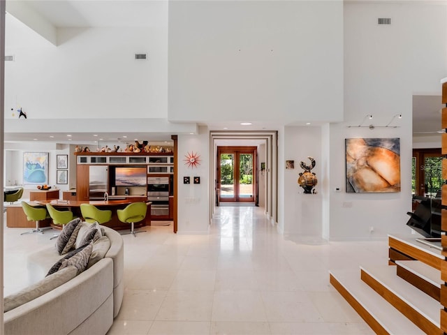 living room with a towering ceiling