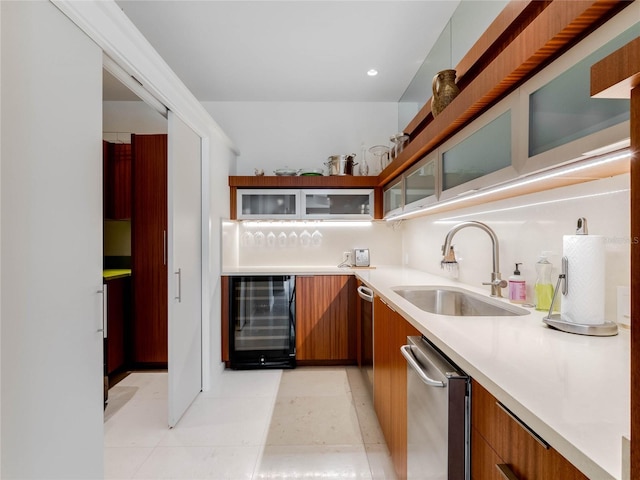 kitchen featuring wine cooler, dishwasher, sink, and light tile patterned floors