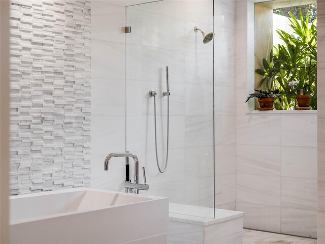 bathroom featuring separate shower and tub and sink