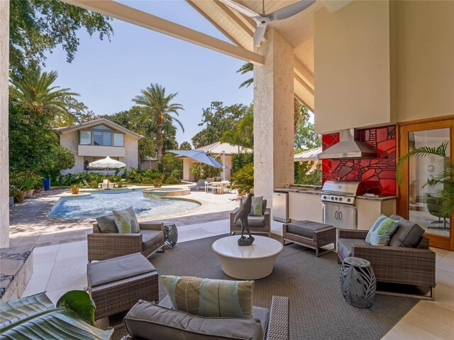 view of patio / terrace with a grill, an outdoor living space, a swimming pool with hot tub, and exterior kitchen