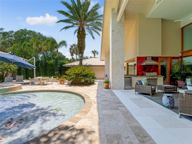 view of pool featuring sink, an outdoor kitchen, a grill, an in ground hot tub, and a patio