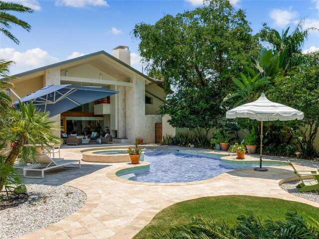 view of swimming pool with an in ground hot tub and a patio