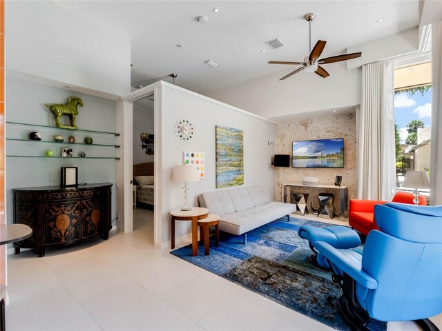 living room featuring ceiling fan and light tile patterned floors