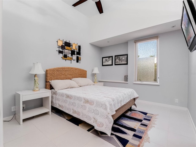 tiled bedroom featuring ceiling fan