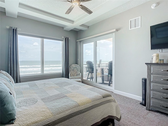 carpeted bedroom featuring access to exterior, visible vents, baseboards, beamed ceiling, and a textured ceiling