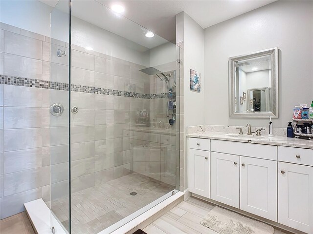 full bathroom featuring vanity and a shower stall