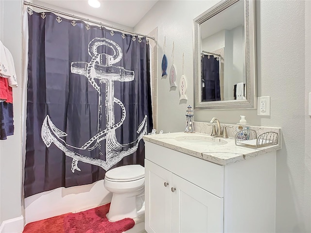 bathroom with toilet, curtained shower, and vanity