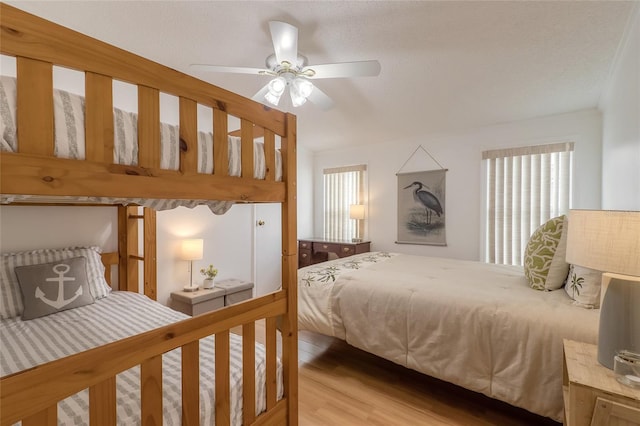 bedroom featuring ceiling fan, a textured ceiling, and hardwood / wood-style flooring