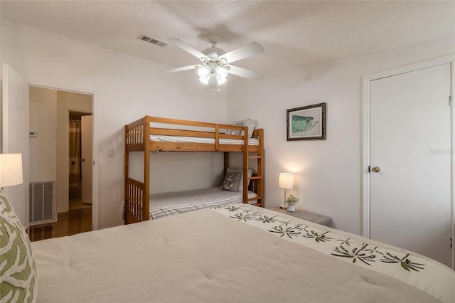 unfurnished bedroom with ceiling fan, wood-type flooring, and a textured ceiling