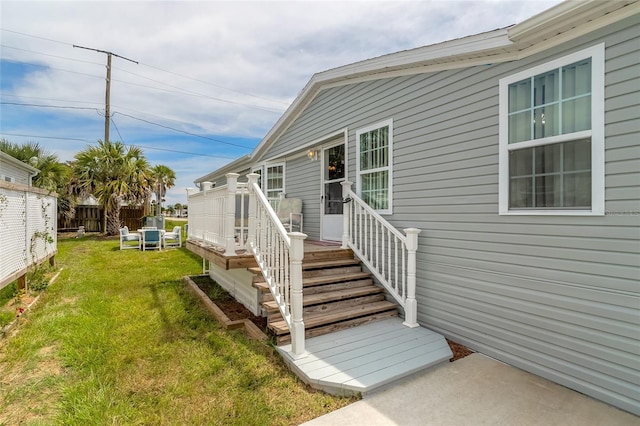 doorway to property featuring a yard